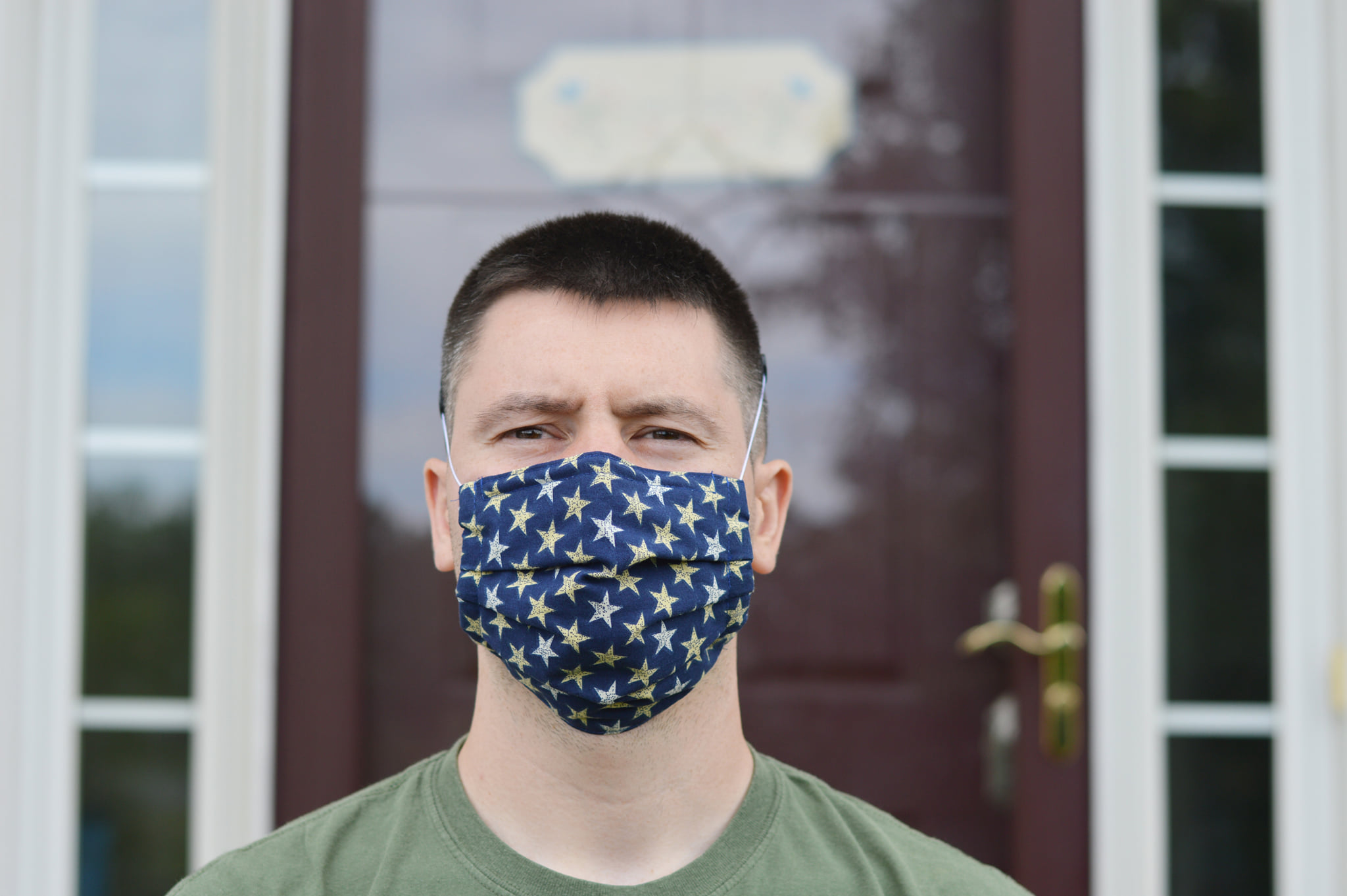 Male Model wearing a blue homemade cotton-fabric mask with white and gold star pattern