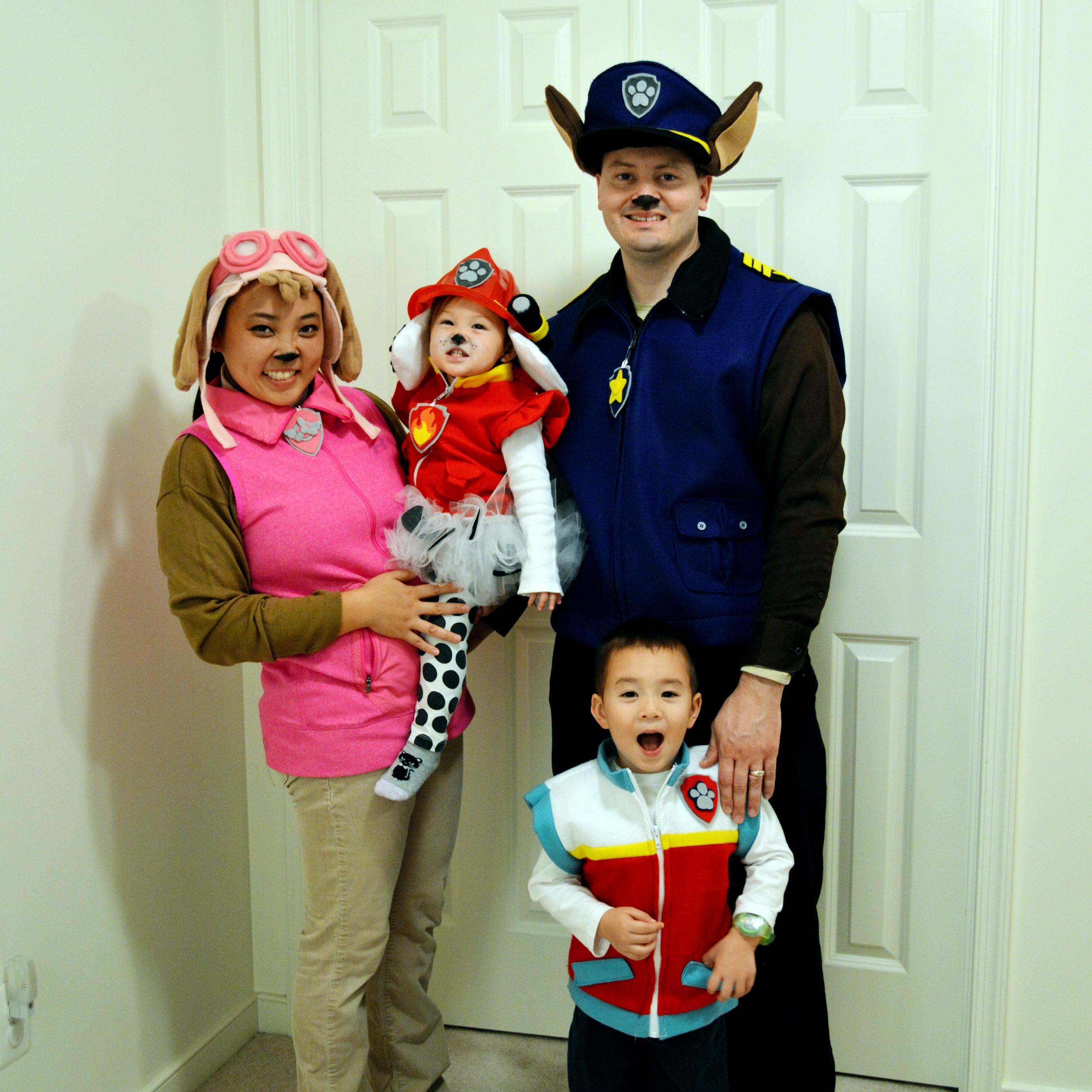 Familiyof four wearing the character vests with dog ID tags, hat/ears, and tails